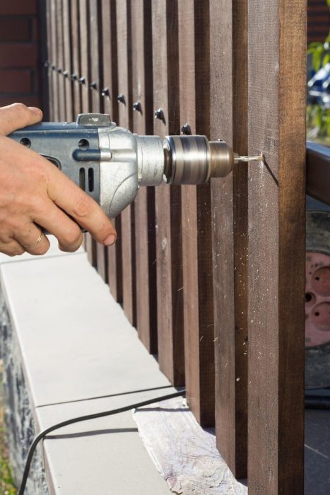 man-hands-drilling-wooden-fence-metal-construction-building-wooden-fence-with-drill-screw-close-up-his-hand-tool-diy-concept_635416-2019.jpg
